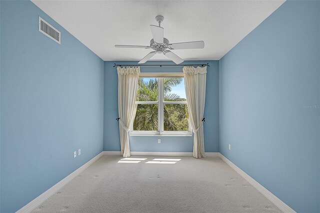 unfurnished room featuring carpet and ceiling fan