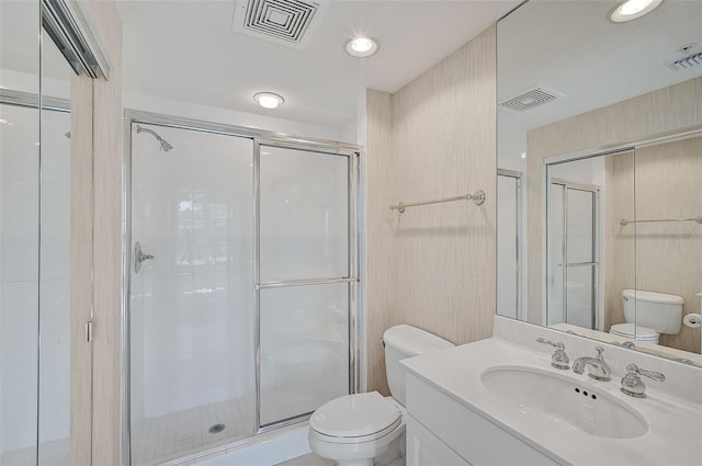 bathroom with walk in shower, vanity, and toilet