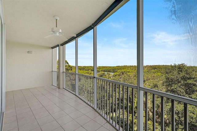 unfurnished sunroom featuring ceiling fan