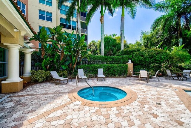 view of swimming pool with a community hot tub and a patio