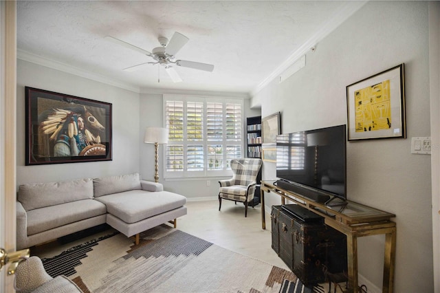 living room with ceiling fan, crown molding, and light wood-type flooring