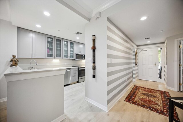 entrance foyer with light wood-type flooring and sink