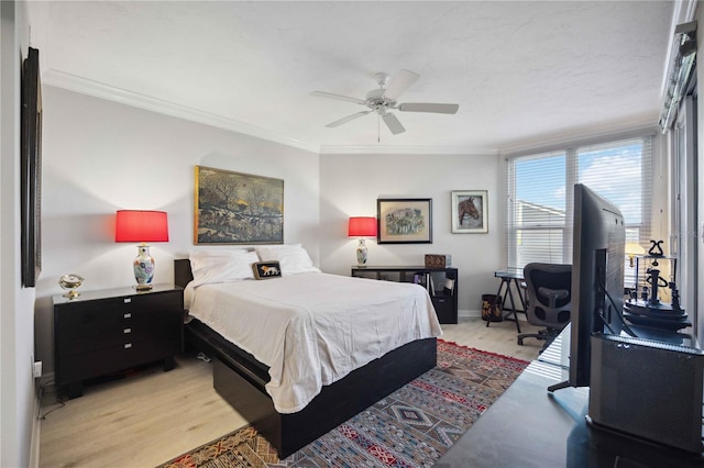 bedroom featuring ceiling fan, light hardwood / wood-style floors, and crown molding