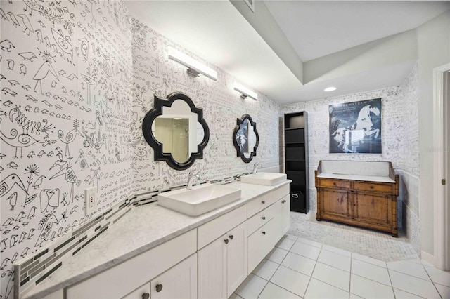 bathroom with double vanity, tasteful backsplash, and tile patterned flooring