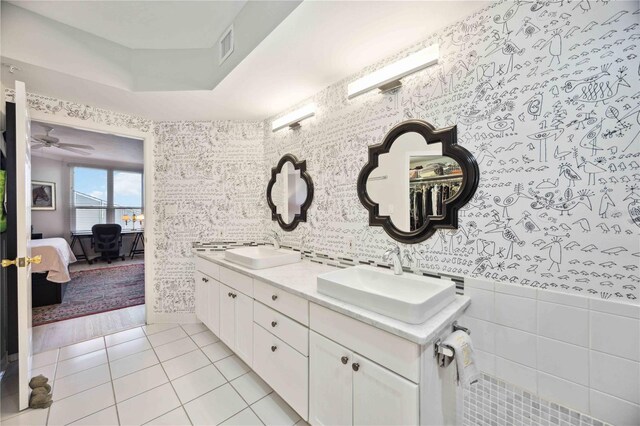 bathroom with tile walls, ceiling fan, dual bowl vanity, and hardwood / wood-style flooring