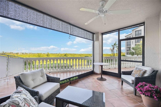 sunroom featuring ceiling fan