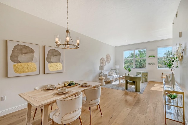 dining area featuring a notable chandelier and light hardwood / wood-style flooring