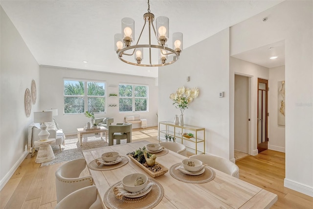 dining space with a chandelier and light hardwood / wood-style floors