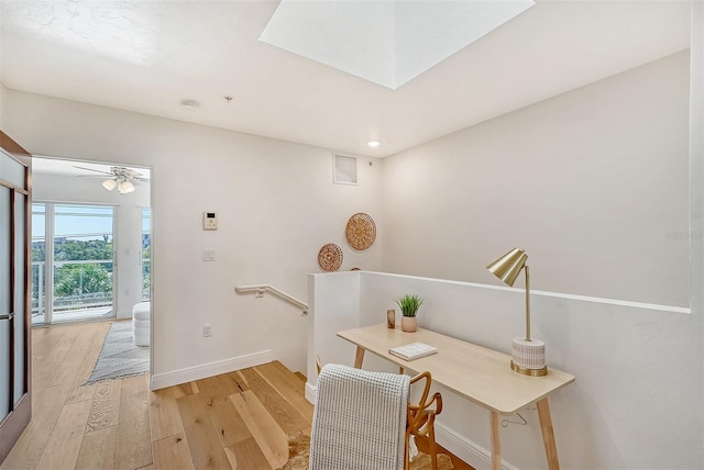 office with ceiling fan and light wood-type flooring