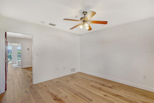 spare room featuring light hardwood / wood-style flooring and ceiling fan