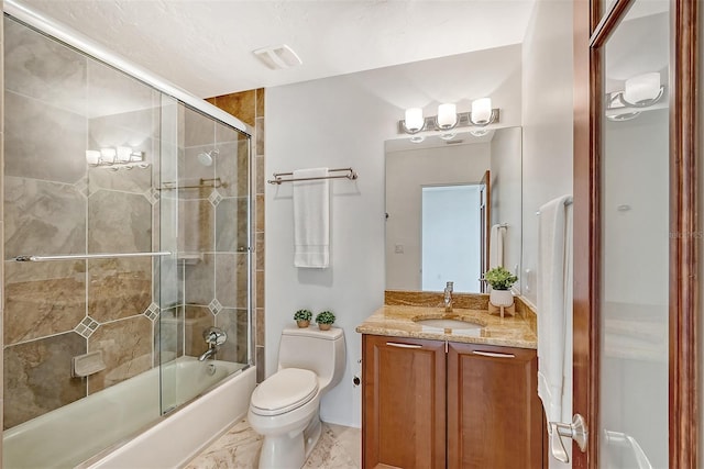 full bathroom featuring vanity, bath / shower combo with glass door, and toilet