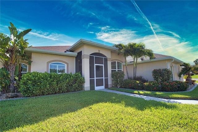 ranch-style home with a front lawn