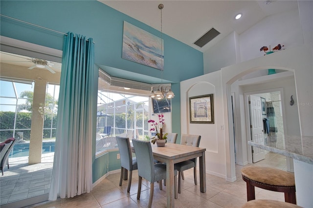 tiled dining area featuring high vaulted ceiling and ceiling fan