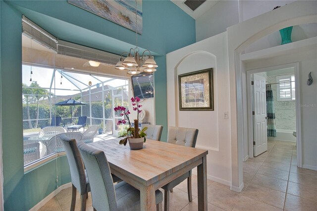 tiled dining area featuring a chandelier