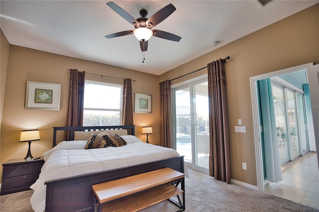 tiled bedroom with ceiling fan, access to outside, and a textured ceiling