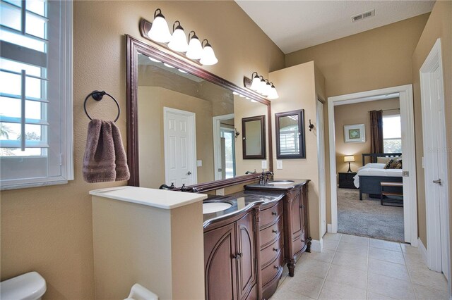 bathroom featuring tile patterned flooring and double vanity