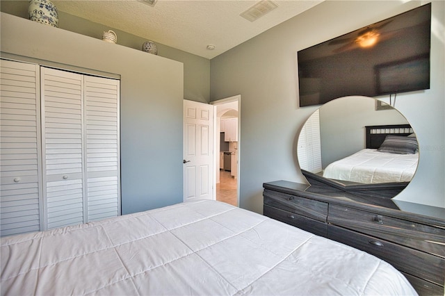 bedroom with a closet and a textured ceiling