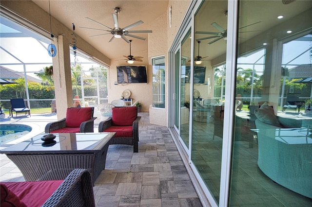 view of patio / terrace with ceiling fan, glass enclosure, and an outdoor living space