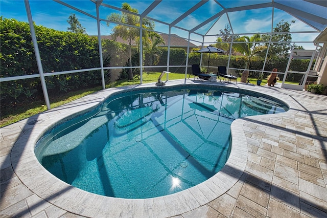 view of swimming pool featuring glass enclosure and a patio area