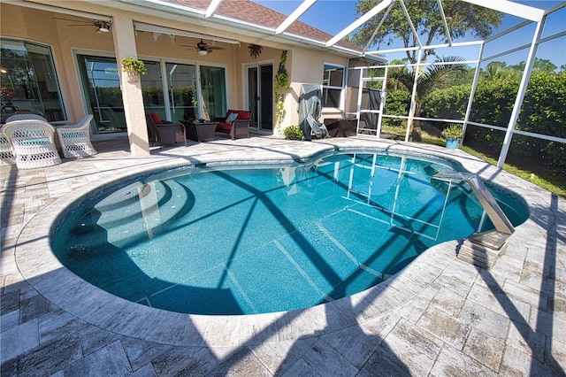 view of swimming pool featuring ceiling fan, an outdoor hangout area, a patio area, and a lanai