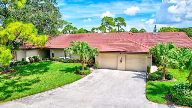 view of front of house with a garage and a front yard