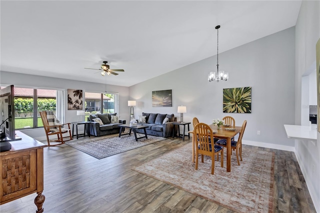 dining room with hardwood / wood-style floors, ceiling fan with notable chandelier, and lofted ceiling