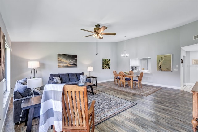 living room with high vaulted ceiling, ceiling fan with notable chandelier, and hardwood / wood-style floors