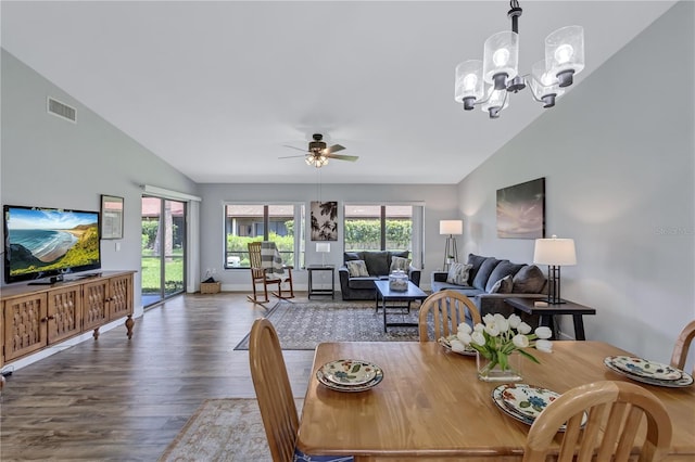 dining room featuring ceiling fan with notable chandelier, vaulted ceiling, and hardwood / wood-style floors