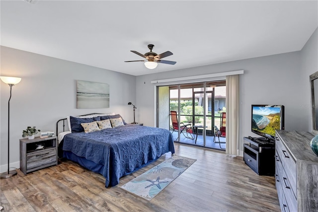 bedroom featuring hardwood / wood-style floors, access to outside, and ceiling fan