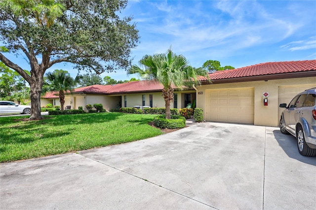 view of front of home with a front lawn and a garage