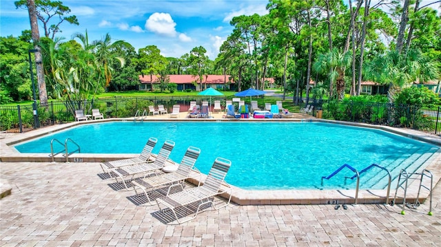 view of swimming pool with a patio area