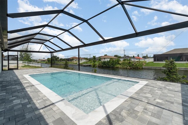 view of pool with a patio area, a lanai, and a water view