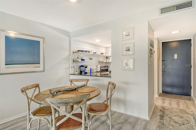 dining room with light wood-type flooring