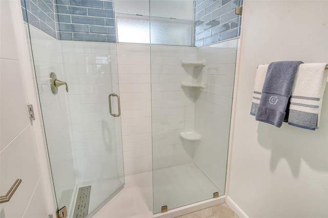 bathroom featuring tile patterned flooring and a shower with door