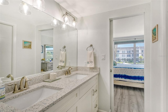 bathroom featuring dual vanity and wood-type flooring