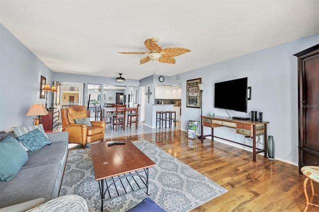 living room with ceiling fan and hardwood / wood-style floors