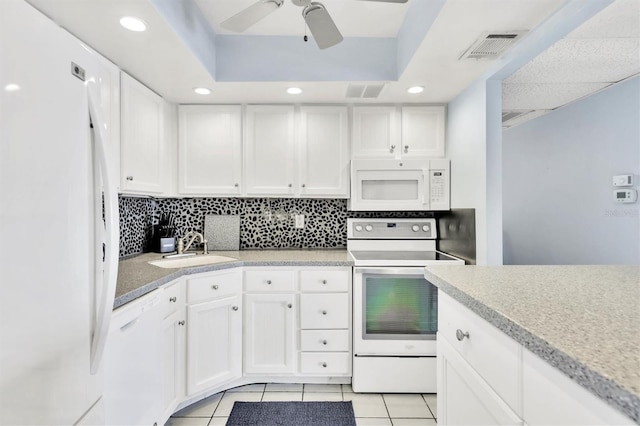 kitchen featuring light tile patterned floors, visible vents, backsplash, a sink, and white appliances