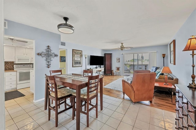 dining room featuring light hardwood / wood-style flooring and ceiling fan