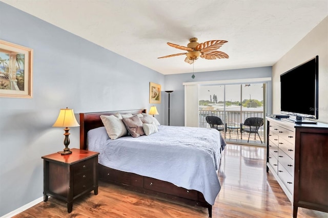 bedroom featuring light hardwood / wood-style floors, ceiling fan, and access to exterior