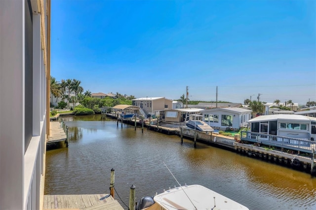 view of dock with a water view and a residential view