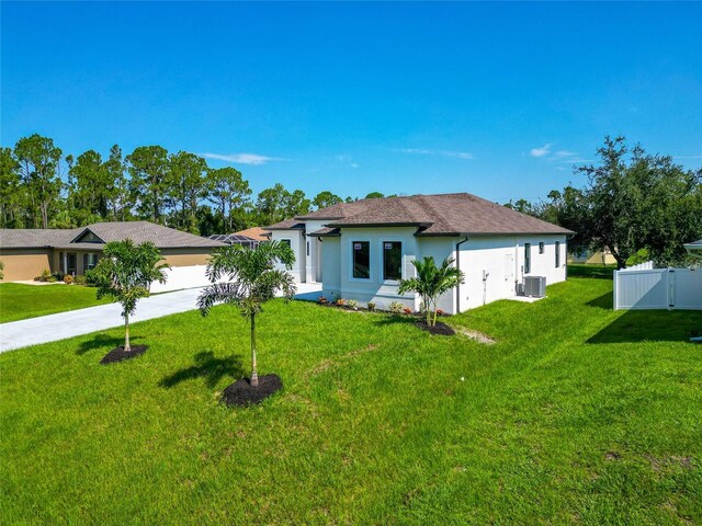 view of front of house featuring central AC unit and a front lawn