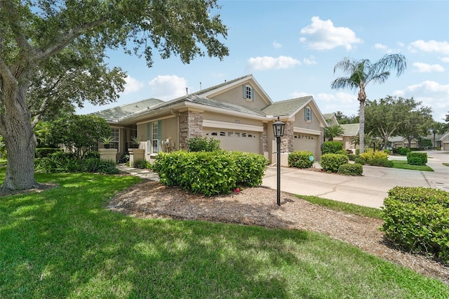 view of front of property with a front yard and a garage