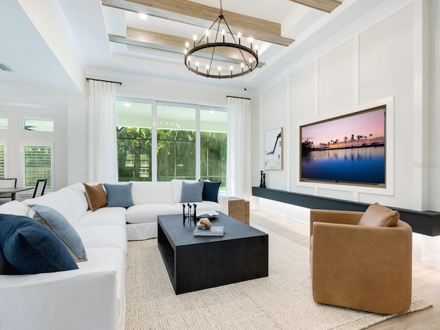 living room featuring crown molding, light hardwood / wood-style flooring, beamed ceiling, and a chandelier