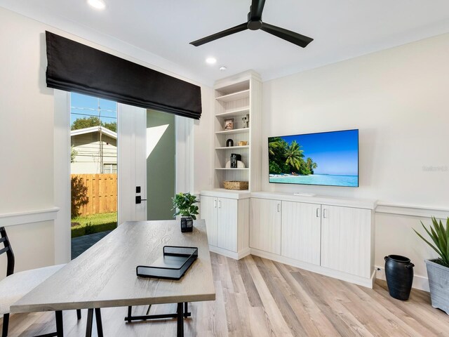 home office with ceiling fan and light hardwood / wood-style flooring