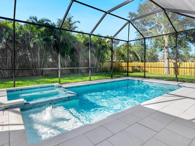 view of swimming pool with an in ground hot tub, a yard, glass enclosure, and a patio area