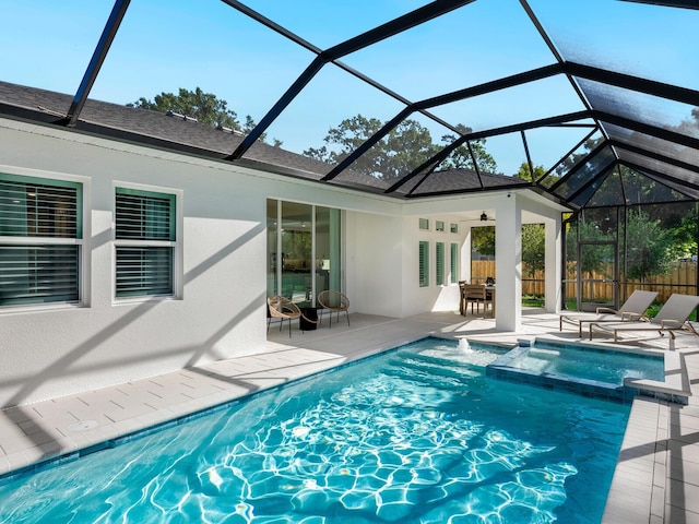 view of swimming pool with a lanai, ceiling fan, and a patio area