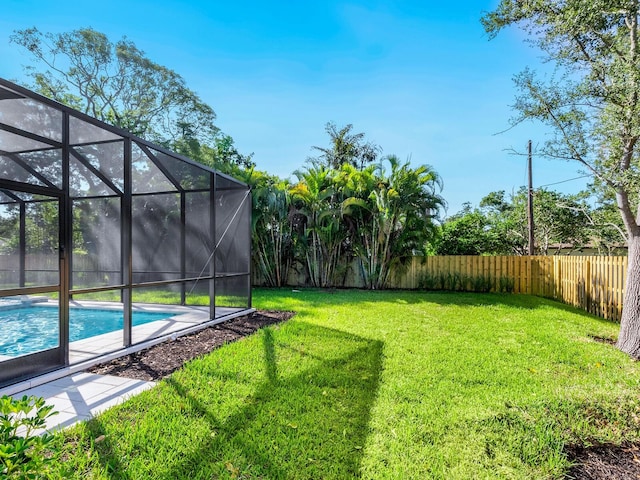 view of yard with a lanai and a fenced in pool