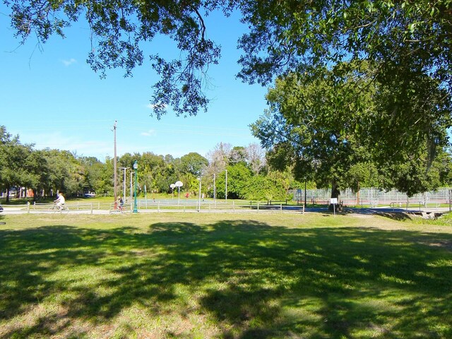 view of community with a yard and a rural view