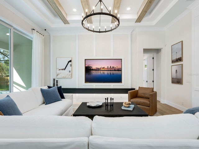 living room featuring hardwood / wood-style flooring, crown molding, and a chandelier