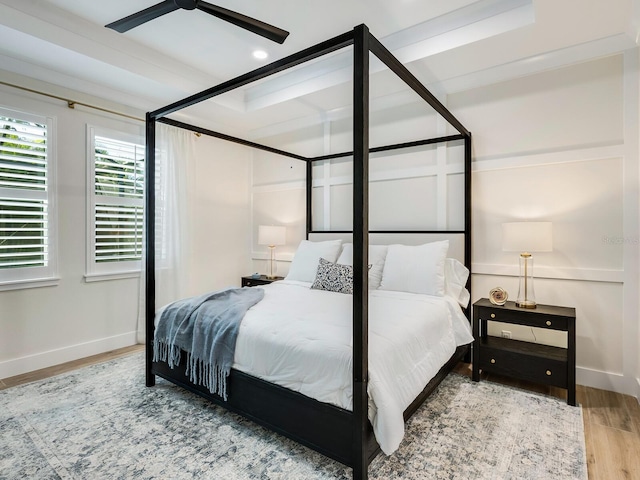 bedroom with ceiling fan and wood-type flooring